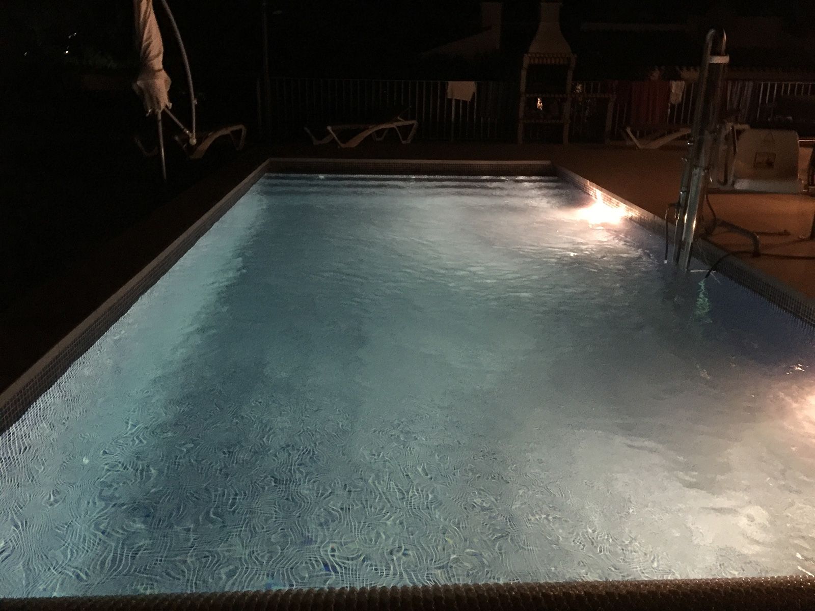 Swimming pool with LED colour lights at night